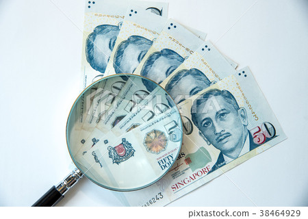 Singapore dollar and magnifying glass Singapore dollar and magnifying glass 38464929