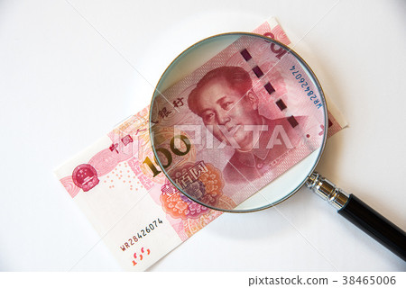 Chinese yuan and magnifying glass 38465006