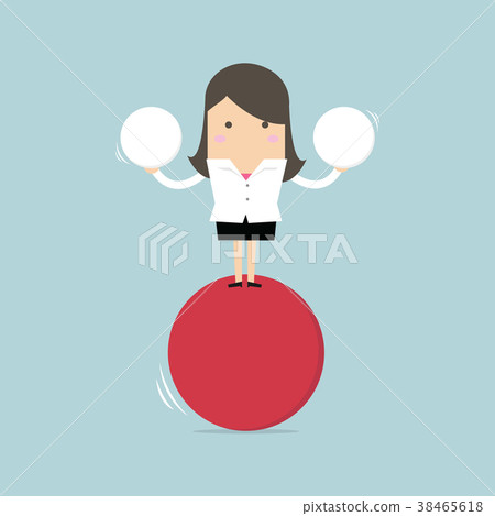 Businesswoman balancing on red ball holding sphere Businesswoman balancing on red ball holding sphere 38465618
