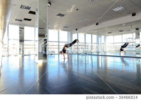 Young boy doing hand stretching at dancing studio. Young boy doing hand stretching at dancing studio. 38466814