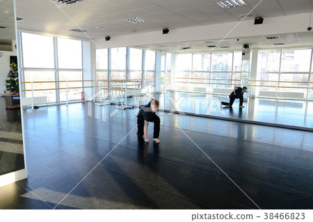 Young boy doing hand stretching at dancing studio. Young boy doing hand stretching at dancing studio. 38466823