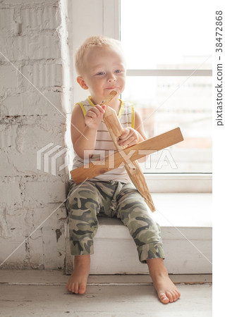 Cute Child Boy with Wooden Plane Toy at Home Cute Child Boy with Wooden Plane Toy at Home 38472868