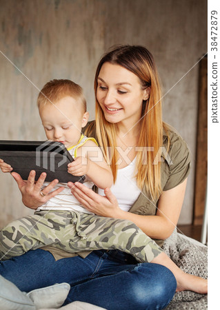 Young smiling mother with son using digital tablet 38472879