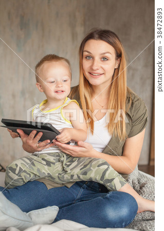 Beautiful smiling mother and son using digital  38472893
