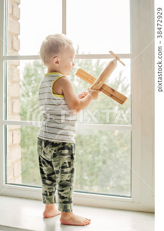 Little boy playing with wooden toy 38472929