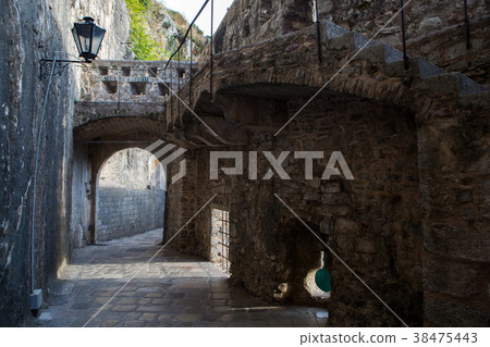 stone old corridor with round window 38475443