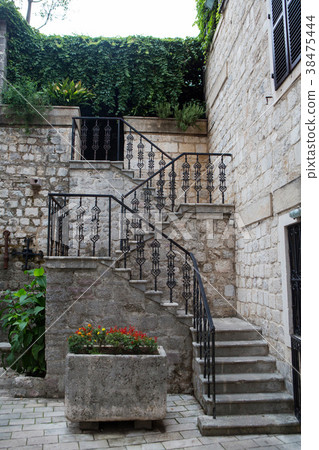 staircase with iron railings and flowers in 38475444