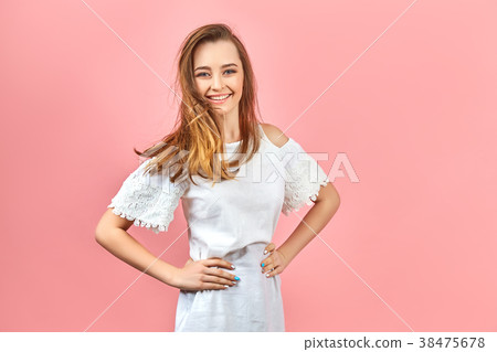 Beautiful girl wearing white dress and posing on 38475678