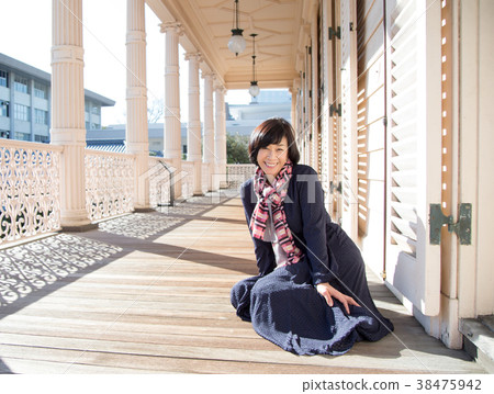 Big balcony woman by the wall something flashy by the wall happy full woman 38475942