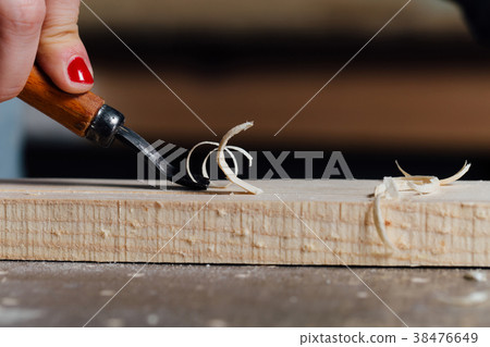 close-up carpenter woman's hand with a red 38476649