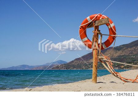 Life preserver on sandy beach somewhere near at Life preserver on sandy beach somewhere near at 38476811