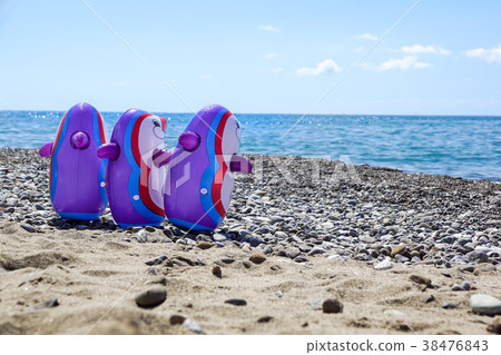 playing penguins on the sand of the beach near the 38476843