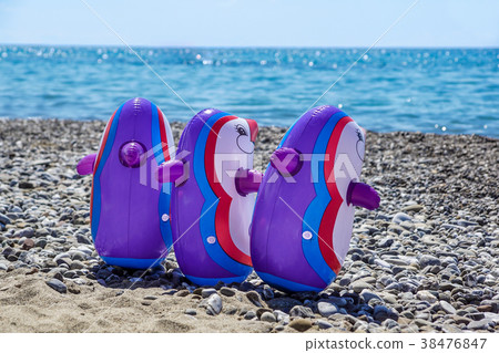 playing penguins on the sand of the beach near the 38476847