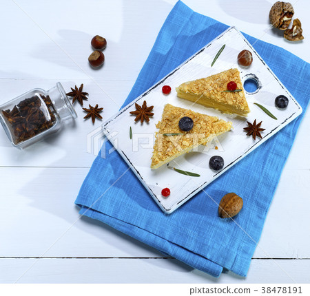 two baked cakes Napoleon with cream 38478191