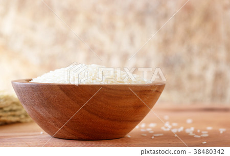 White rice in bowl on wooden background. White rice in bowl on wooden background. 38480342