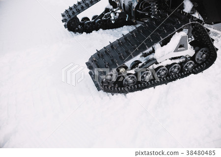 close up on ratrak wheels on the snow 38480485