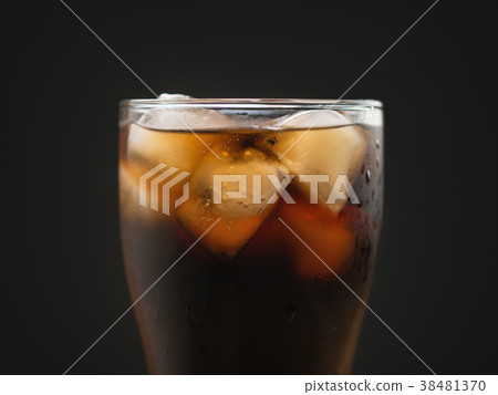 glass of cola with ice over black background glass of cola with ice over black background 38481370