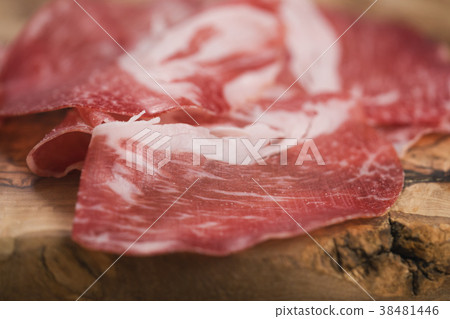closeup cured italian coppa on olive wood board closeup cured italian coppa on olive wood board 38481446