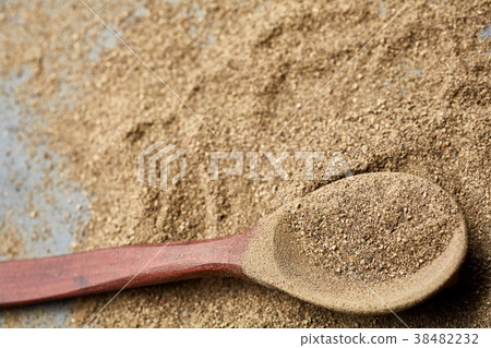 Top view of a wooden spoon full of grind black Top view of a wooden spoon full of grind black 38482232