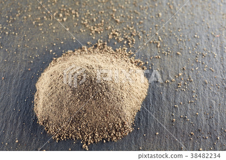 A pile of grinded black pepper on dark background A pile of grinded black pepper on dark background 38482234