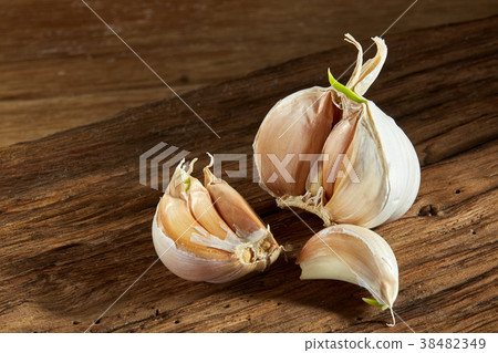 Garlic close up on wooden plate on rustic Garlic close up on wooden plate on rustic 38482349