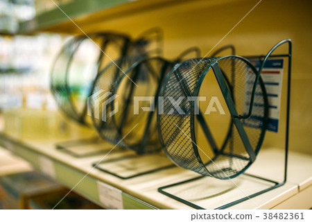 Pet shop, shelf with hamster wheels, closeup Pet shop, shelf with hamster wheels, closeup 38482361