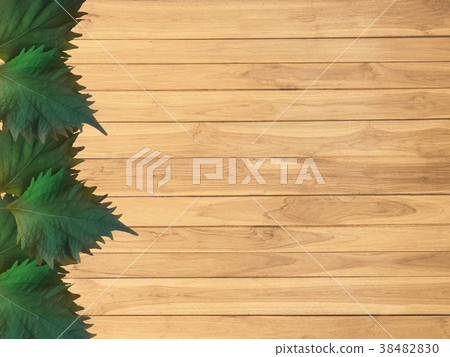 Oba leaves on wooden boards. 38482830