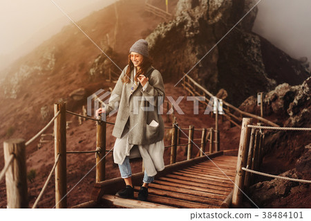 Girl climbs the path to the mountain Girl climbs the path to the mountain 38484101