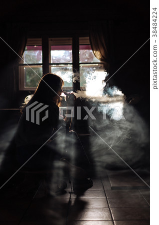 The girl smoke electronic cigarette The girl smoke electronic cigarette 38484224