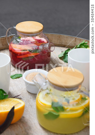orange tea with ginger and raspberries on a wooden orange tea with ginger and raspberries on a wooden 38484418