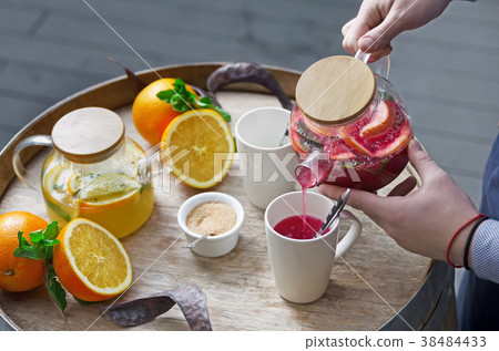 orange tea with ginger and raspberries on a wooden orange tea with ginger and raspberries on a wooden 38484433
