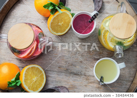 orange tea with ginger and raspberries on a wooden orange tea with ginger and raspberries on a wooden 38484436