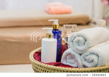 Massage item and Spa Oil in Basket on Bed Massage item and Spa Oil in Basket on Bed 38484665