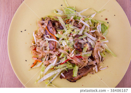 Noodles with bacon, lettuce leaves, carrots, haric 38486187