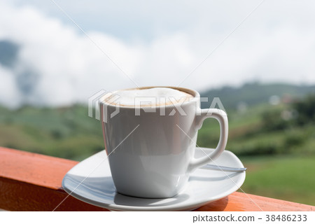 Close up white cup of hot coffee on balcony edge Close up white cup of hot coffee on balcony edge 38486233