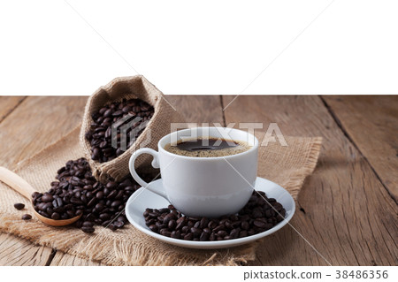 coffee cup and coffee beans on old wood plank coffee cup and coffee beans on old wood plank 38486356