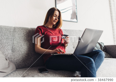 Woman doing online shopping with laptop and credit 38487990