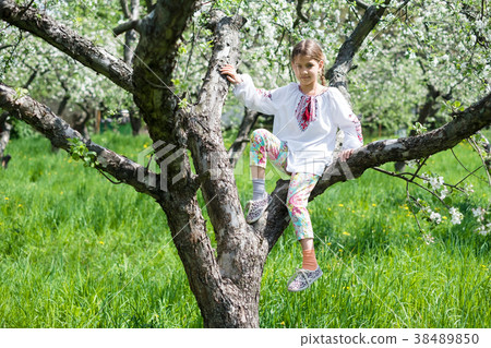 Cute girl dressed in embroidery in the garden Cute girl dressed in embroidery in the garden 38489850