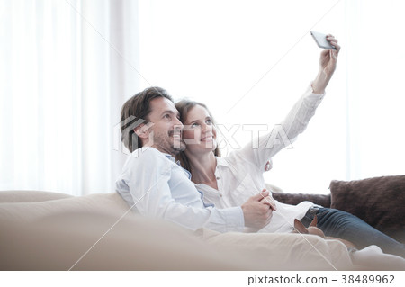 Happy couple taking selfie Happy couple taking selfie 38489962