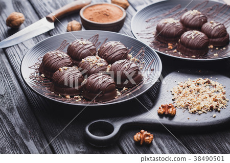 delicious mini chocolate cakes with walnut on a 38490501