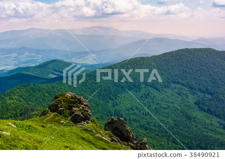 grassy hillside over the cliff in mountains 38490921