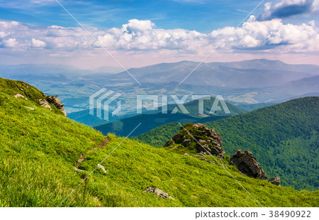 grassy hillside over the cliff in mountains 38490922