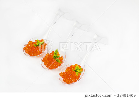 Plastic spoons with fish caviar on a white backgro Plastic spoons with fish caviar on a white backgro 38491409