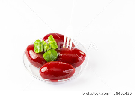 Olives in a small plastic plate on a white backgro 38491439