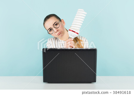 Attractive woman with computer and bulb 38491618
