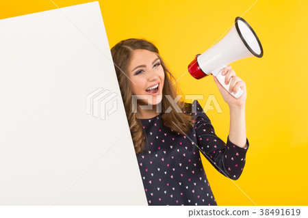 Attractive woman with blank banner and loudspeaker 38491619