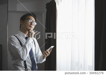 Stylish businessman using a smartphone 38492279