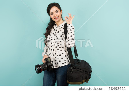 Young woman with camera and its case 38492611