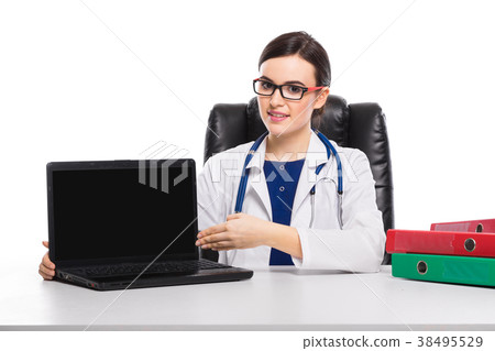 Young woman doctor with stethoscope sitting on the Young woman doctor with stethoscope sitting on the 38495529