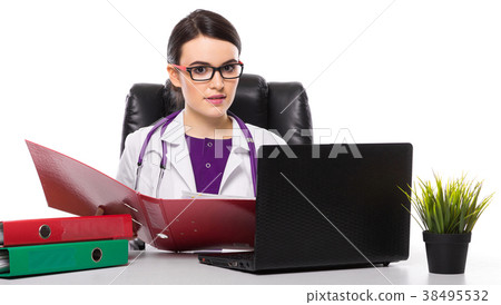 Young woman doctor with stethoscope sitting on the Young woman doctor with stethoscope sitting on the 38495532